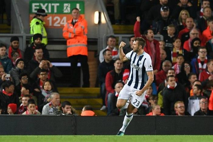 West Bromwich Albion's defender Gareth McAuley celerbates scoring their first goal during the English Premier League football match between Liverpool and West Bromwich Albion at Anfield in Liverpool, north west England on October 10, 2016