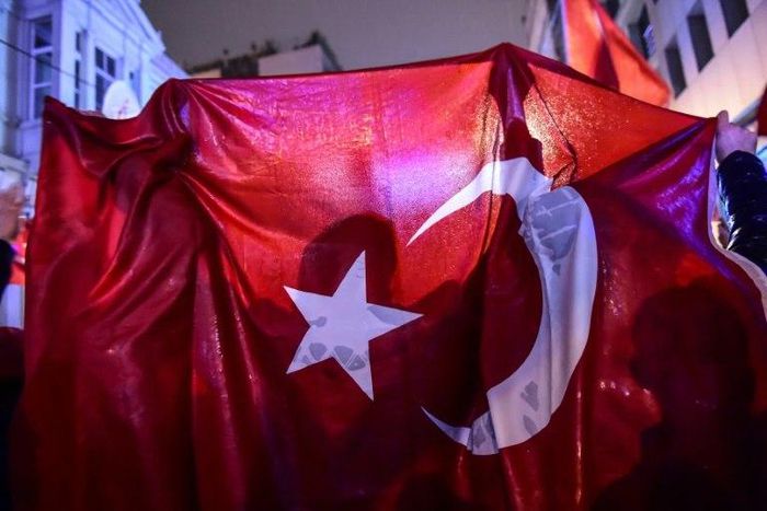 A protester waves a Turkish national flag during a demonstration in front of the Netherlands consulate in Istanbul on March 12, 2017
