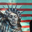 An Iranian woman walks past a mural on the wall of the former US embassy in Tehran
