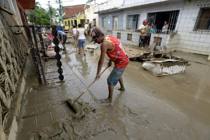 Residents of the city of Barreiros clean their houses affectd by floods, due to heavy rains in Pernambuco state, northeastern Brazil, on May 30, 2017