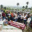 Relatives and friends of Deisy Rosero, 26, pray during her funeral at a cemetery in Mocoa, Putumayo department, southern Colombia on April 3, 2017
