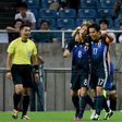 Japanese forward Genki Haraguchi (centre) celebrates with captain Makoto Hasebe after scoring the opening goal against Iraq during a World Cup qualifier in Saitama on October 6, 2016