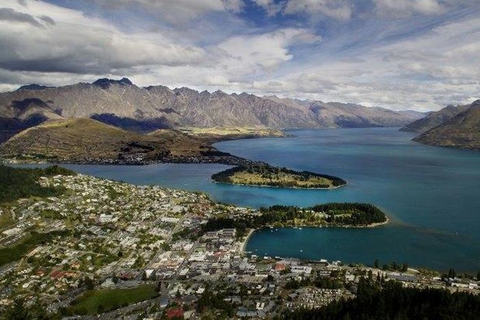 Views like this -- of Queenstown and Lake Wakatipu, with the Remarkables mountain range in the background -- are one of the reasons tourists flock to New Zealand. But strong economic growth is placing strains on the environment, the OECD is warning