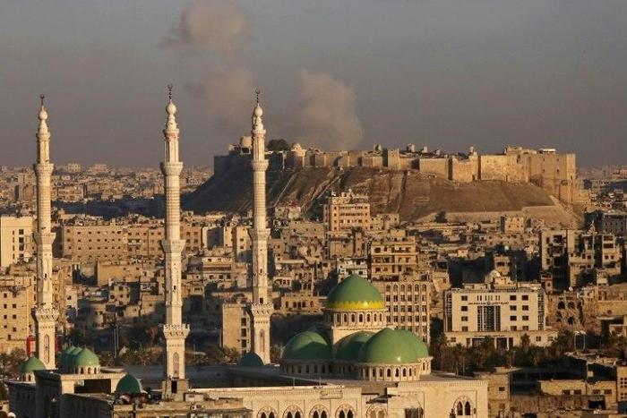 Smoke billows near Aleppo's historic citadel during fighting between Syrian regime forces and rebel fighters, on December 3, 2016