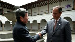 The representative of Colombian guerrilla group ELN, Pablo Beltran (L), and representative of the Colombian government Juan Camilo Restrepo shake hands at the Palacio Arzobispal in Quito where they arrived to hold a meeting on March 3, 2017