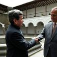 The representative of Colombian guerrilla group ELN, Pablo Beltran (L), and representative of the Colombian government Juan Camilo Restrepo shake hands at the Palacio Arzobispal in Quito where they arrived to hold a meeting on March 3, 2017