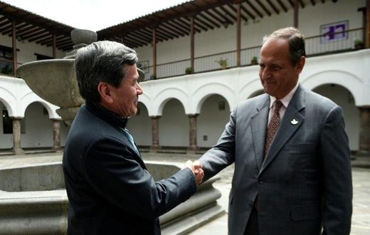 The representative of Colombian guerrilla group ELN, Pablo Beltran (L), and representative of the Colombian government Juan Camilo Restrepo shake hands at the Palacio Arzobispal in Quito where they arrived to hold a meeting on March 3, 2017