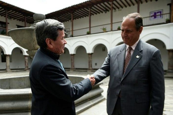 The representative of Colombian guerrilla group ELN, Pablo Beltran (L), and representative of the Colombian government Juan Camilo Restrepo shake hands at the Palacio Arzobispal in Quito where they arrived to hold a meeting on March 3, 2017