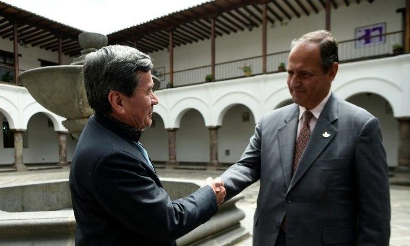 The representative of Colombian guerrilla group ELN, Pablo Beltran (L), and representative of the Colombian government Juan Camilo Restrepo shake hands at the Palacio Arzobispal in Quito where they arrived to hold a meeting on March 3, 2017