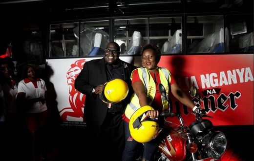 Pilsner Marketing Manager, Samuel Wasswa and Pilsner Senior Brand Manager, Truphena Malaki on the KBL/Pilsner bike to be worn