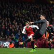 Bayern Munich's forward Robert Lewandowski (R) scores from a penalty during the UEFA Champions League last 16 second leg football match between Arsenal and Bayern Munich at The Emirates Stadium in London on March 7, 2017