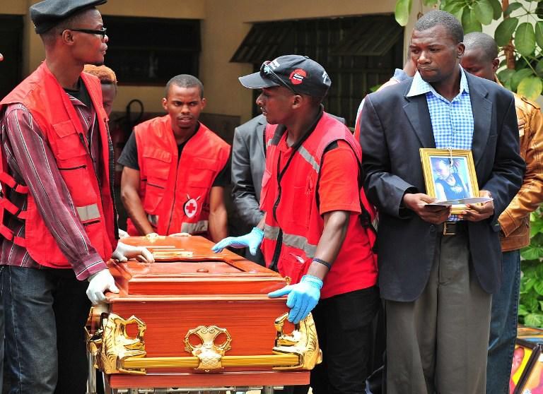 Red Cross officials help carry out a coffin from the morgue during a past crisis