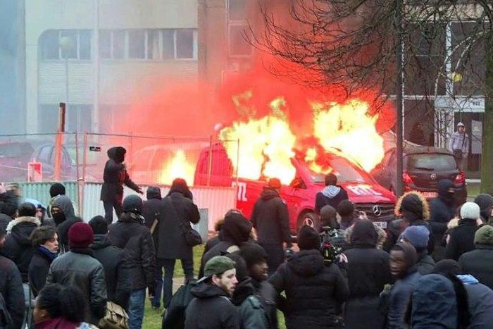 Image grab taken from an AFPTV video shows a van of radio station RTL burning during clashes on the edge of a rally in Bobigny, outside Paris on February 11, 2017 to denounce police brutality after a black man was allegedly raped