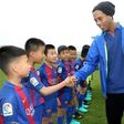 Brazilian player Ronaldinho meets children at the launch of a Barcelona football academy on the southern Chinese island of Hainan, on February 24, 2017