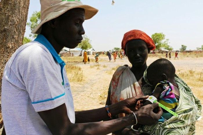 A baby gets a Mid-Upper Arm Circumference (MUAC) test for malnutrition in Thonyor, Leer County of South Sudan