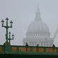 Pedestrians walk through the fog as they cross Southwark Bridge in London as St Paul's Cathedral looms in the background on January 23, 2017