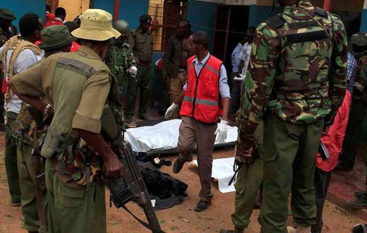 Police officers stand by dead bodies after an attack by Islamist militants from the Somali group al Shabaab in Mandera, Kenya, October 6, 2016.
