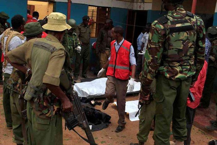 Police officers stand by dead bodies after an attack by Islamist militants from the Somali group al Shabaab in Mandera, Kenya, October 6, 2016.