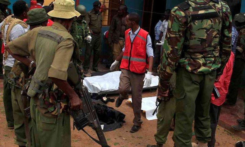 Police officers stand by dead bodies after an attack by Islamist militants from the Somali group al Shabaab in Mandera, Kenya, October 6, 2016.