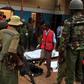 Police officers stand by dead bodies after an attack by Islamist militants from the Somali group al Shabaab in Mandera, Kenya, October 6, 2016.