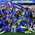 Chelsea's players gather on the pitch with the English Premier League trophy at Stamford Bridge in London, on May 21, 2017