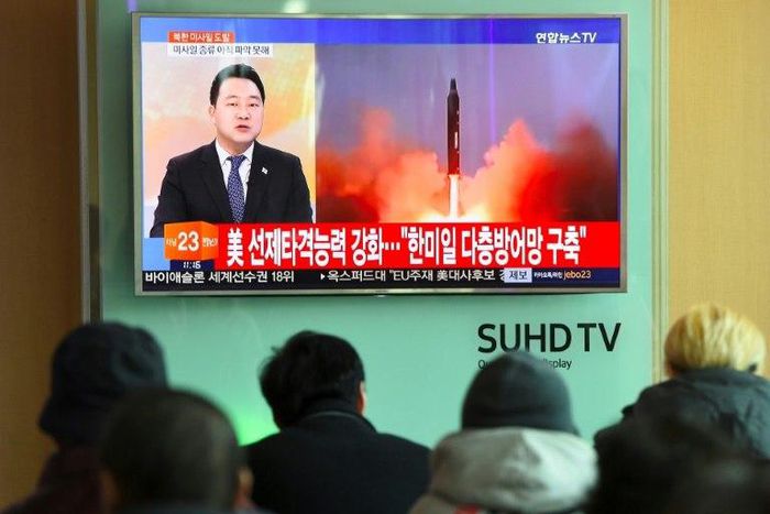 People watch the news showing file footage of a North Korean missile launch at a railway station in Seoul on February 12, 2017