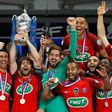 Paris Saint-Germain's Maxwell (C) holds the trophy as he celebrates winning the French Cup final football match against Angers (SCO) on May 27, 2017, at the Stade de France in Saint-Denis