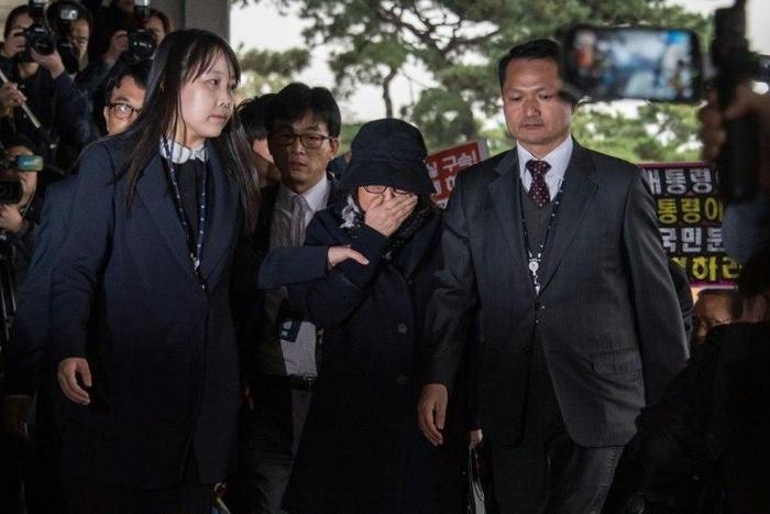 Choi Soon-Sil (C) is escorted to the Seoul Central District Prosecutor's Office, on October 31, 2016