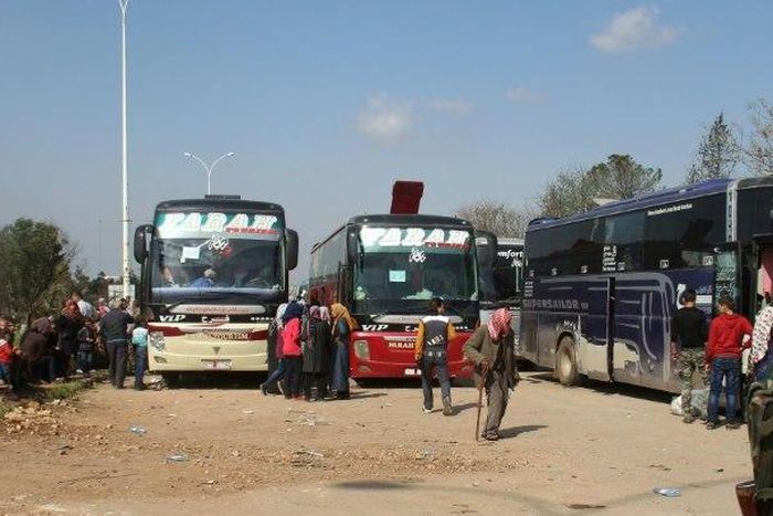Syrians wait in rebel-held Rashidin, west of Aleppo city, following delays in evacuating them, on April 15, 2017