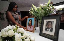 Chichi Wamalwa holding portraits of Yvonne and father Kijana Wamalwa at their Karen home