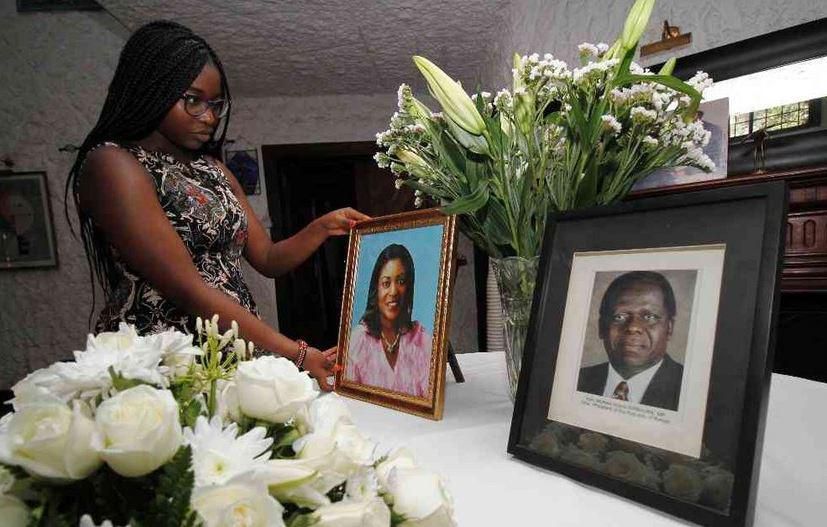Chichi Wamalwa holding portraits of Yvonne and father Kijana Wamalwa at their Karen home
