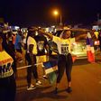 People celebrate in the streets of Banjul on January 21, 2017 after hearing of the confirmed departure of former Gambian leader Yahya Jammeh from the country