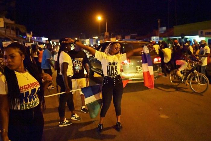 People celebrate in the streets of Banjul on January 21, 2017 after hearing of the confirmed departure of former Gambian leader Yahya Jammeh from the country