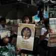 People hold newspaper images of Thailand's new King Maha Vajiralongkorn outside the Grand Palace in Bangkok
