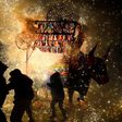 People run away from fireworks exploding around them next to a traditional "torito" (little bull) made of paper, wood and fireworks, during the San Juan de Dios festival in Tultepec, on March 8, 2017