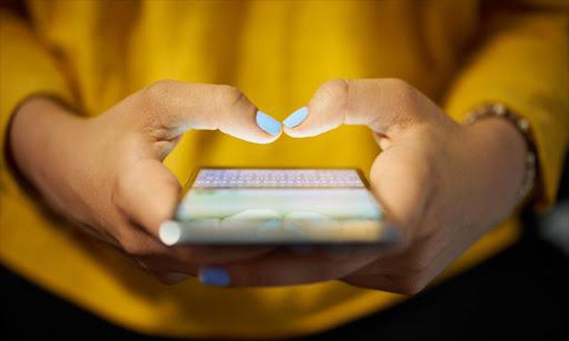 A person using their mobile phone (Twitter)