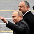 Russian President Vladimir Putin (L) and his Moldovan counterpart Igor Dodon walk on Red Square after the Victory Day military parade in Moscow on May 9, 2017