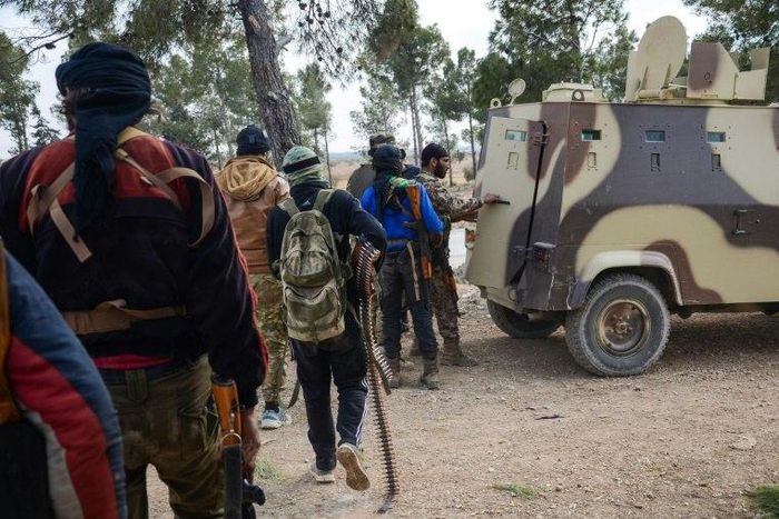 Rebel fighters queue to enter an armoured vehicle near the town of Bizaah northeast of the city of Al-Bab on February 4, 2017