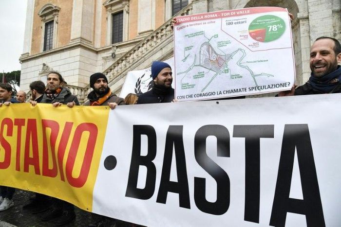 Supporters of Italian football team AS Roma hold a map of the new proposed stadium in front of City Hall on Capitoline Hill at Piazza del Campidoglio in Rome on February 24, 2017