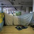 Hundreds of refugees and migrants are living in poor conditions inside the disused Hellenikon airport