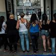 Wives and widows of military policemen block the entrance to the military police station in Rio de Janeiro on February 10, as they demand back pay for their relatives