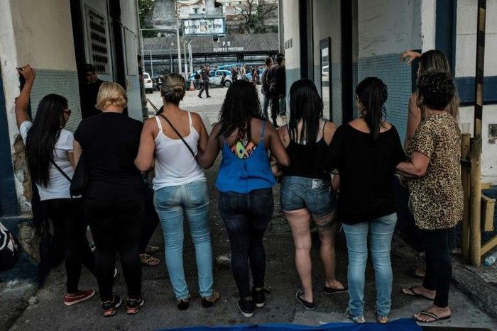 Wives and widows of military policemen block the entrance to the military police station in Rio de Janeiro on February 10, as they demand back pay for their relatives