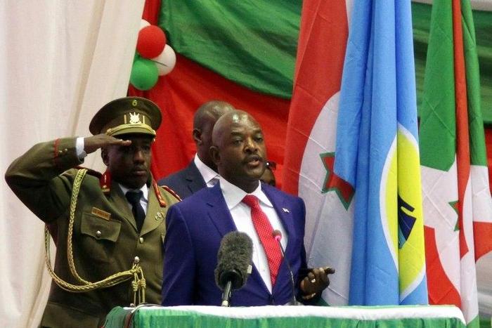 A Burundi journalist was unharmed after his release by authorities, who arrested him for aiding "insurgents," the term used for people who oppose President Pierre Nkurunziza (R), seen after being sworn in for his controversial third term in 2015