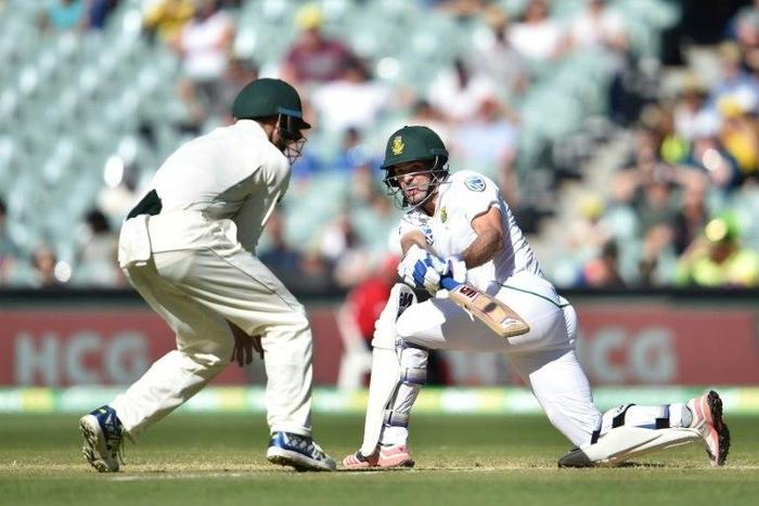 South Africa's Stephen Cook (R) hits a ball past Australia's captain Steve Smith on the third day of the third Test against Australia at the Adelaide Oval in Adelaide on November 26, 2016
