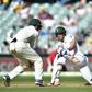South Africa's Stephen Cook (R) hits a ball past Australia's captain Steve Smith on the third day of the third Test against Australia at the Adelaide Oval in Adelaide on November 26, 2016