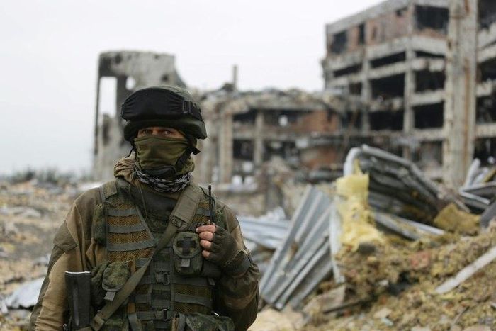 An armed pro-Russian separatist of the self-proclaimed Donetsk People's Republic (DNR) stands in front of the destroyed Donetsk International Airport in Donetsk, eastern Ukraine, on June 1, 2016