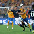 Wolfsburg's forward Mario Gomez (C), Braunschweig's Norwegian defender Gustav Valsvik (2ndR) vie during the Bundesliga Playoff second leg match between Eintracht Braunschweig and VfL Wolfsburg at Eintracht Stadium on May 29, 2017