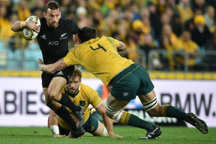 Aaron Cruden of New Zealand (L) is tackled by Kane Douglas of Australia during their Bledisloe Cup match in Sydney, on August 20, 2016
