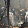 Rescue workers inspect a body after a fireworks warehouse blaze in the Israeli village of Porat on March 14, 2017