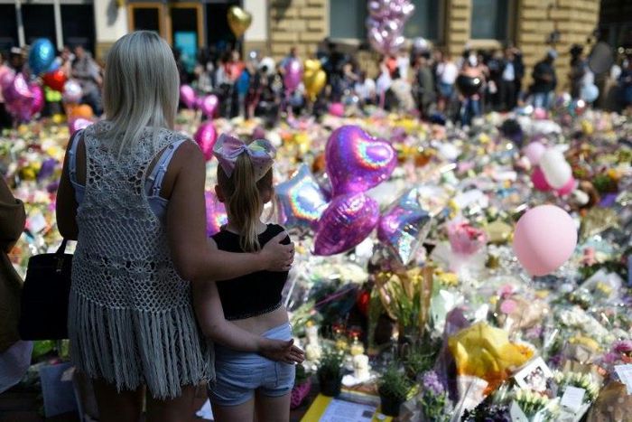 People gather in St Ann's Square in Manchester, northwest England